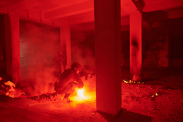 Image showing A professional cameraman captures the intense moments as a group of skilled soldiers embarks on a dangerous mission inside an abandoned building, their actions filled with suspense and bravery