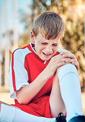 Image showing Soccer, children and knee injury with a boy hurt on a sports field during a competitive game or match. Fitness, football and pain with a kid injured on a grass pitch while playing a sport outdoor