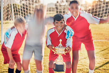 Image showing Trophy, soccer and team in celebration of success as winners of a sports award in a childrens youth tournament. Happy, goals and young soccer players celebrate winning a kids football championship