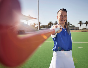 Image showing Woman hockey player, closeup and portrait on field with smile, hockey stick and happy in sunshine. Hockey, outdoor and sport girl at training, exercise and workout in sports ground, arena or stadium