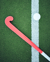 Image showing Turf field, stick hockey and sports ground for game, competition and training gear. Green pitch or grass flatlay at a sport event with workout, exercise or athlete equipment and ball on a playground