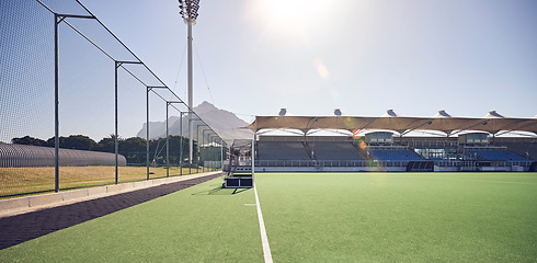 Image showing Field, sports and hockey ground at empty stadium for fitness, training or professional game day. Competition, exercise or sport playground for athletic cardio turf with Canada sun flare.