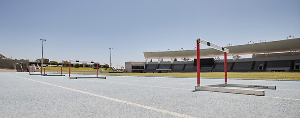 Image showing Stadium, hurdles and sports event for exercise, olympics and training with no people, space and mockup. Sport, venue and hurdling workout at an empty track for workout, healthy lifestyle and venue