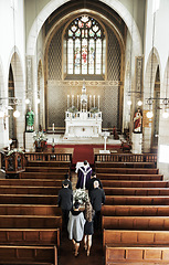 Image showing Funeral, church and people walking together to carry a coffin after a death or loss while inside for memorial service. Family, friends or community feeling sad, grief and mourning at Christian event