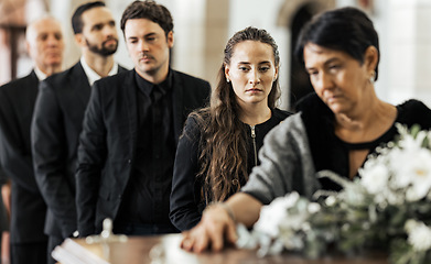 Image showing Funeral, goodbye and family with a coffin in a church during a service in death, mourning and grief. Respect, greeting and sad people in a row with a casket in a cathedral for a burial or memorial