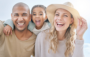 Image showing Summer, blue sky and portrait of young family having fun, laugh and play together. Multicultural mom, dad and girl outdoors on beach holiday and vacation. Love, bonding and couple with kid on weekend