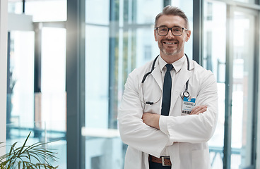 Image showing Mature man, arms crossed and doctor in hospital, healthcare and wellness clinic with trust, vision or help motivation. Portrait, smile or happy consulting medical worker or surgery insurance employee