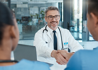 Image showing Handshake, nurse and doctor shaking hands after success in a medical surgery at a trustworthy hospital. Partnership, collaboration and physician welcomes a healthcare worker to the team in a meeting