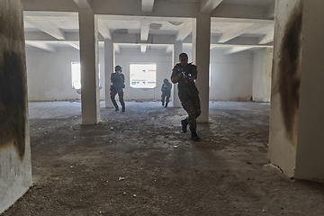 Image showing A professional cameraman captures the intense moments as a group of skilled soldiers embarks on a dangerous mission inside an abandoned building, their actions filled with suspense and bravery