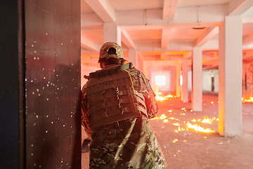 Image showing A group of professional soldiers bravely executes a dangerous rescue mission, surrounded by fire in a perilous building.