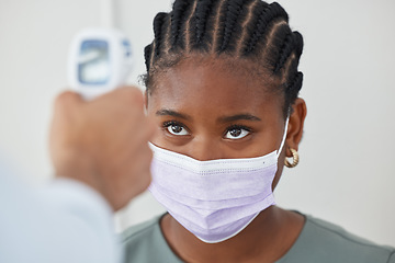 Image showing Face mask, thermometer and covid with doctor, medical expert and healthcare worker in clinic, hospital or wellness center. Black woman or patient with medical checking fever to prevent disease