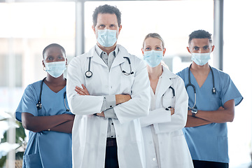 Image showing Doctor, nurse and leadership, covid with face mask for team safety with arms crossed in a medical hospital. Proud, professional and motivated healthcare workers fight covid at clinic together