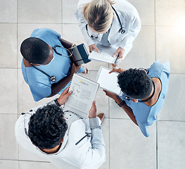 Image showing Doctor, documents and tablet in collaboration above for diagnosis and medical research at the hospital. Healthcare professionals working with technology, data and paperwork in teamwork at a clinic