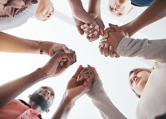 Image showing Community, holding hands or psychology support diversity in mental health workshop, mind or therapy. Zoom on low angle men, women or people in friends trust circle in hope, motivation or anxiety help