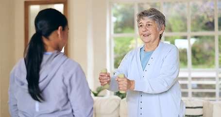 Image showing Dumbbell weights, physiotherapy and an old woman with a caregiver in a nursing home for training. Health, fitness or exercise with a senior patient and nurse in a living room for physical therapy