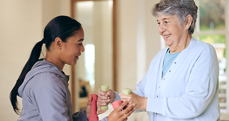 Image showing Dumbbell weights, rehabilitation and an old woman with a caregiver in a nursing home for training. Health, fitness or exercise with a senior patient and volunteer in a living room for physiotherapy