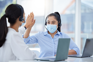 Image showing Covid face mask, high five and call center women in customer service laptop support, telemarketing success and b2b sales. Contact us, receptionist or consultants on office tech in covid 19 compliance