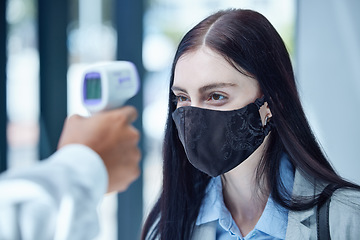 Image showing Doctor, covid and thermometer for healthcare scan to test patient temperature or check for fever or symptoms. Businesswoman with corona mask in exam, scanning face with infrared scanner at the office