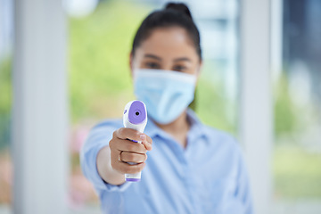 Image showing Hand, woman employee and covid thermometer laser for medical exam, check or covid 19 scan at office. Healthcare worker, mask and scan for corona virus safety and wellness protection at a workplace