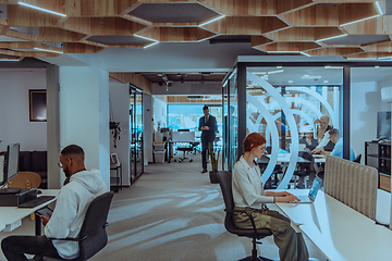 Image showing Young group of business people brainstorming together in a startup space, discussing business projects, investments, and solving challenges.