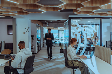 Image showing Young group of business people brainstorming together in a startup space, discussing business projects, investments, and solving challenges.