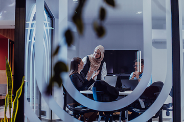 Image showing A diverse group of businessmen collaborates and tests a new virtual reality technology, wearing virtual glasses, showcasing innovation and creativity in their futuristic workspace