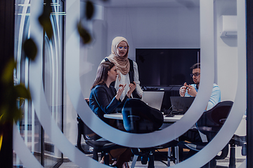 Image showing A diverse group of businessmen collaborates and tests a new virtual reality technology, wearing virtual glasses, showcasing innovation and creativity in their futuristic workspace