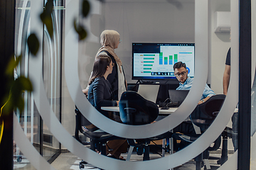 Image showing A diverse group of businessmen collaborates and tests a new virtual reality technology, wearing virtual glasses, showcasing innovation and creativity in their futuristic workspace