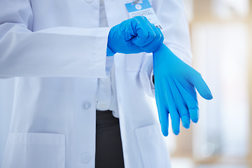 Image showing Hands, gloves and healthcare with a doctor you can trust working alone in a hospital. Health, insurance and medical with a medicine professional putting on a rubber or latex glove for safety