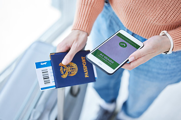 Image showing Phone, covid passport and qr code in the hands of a woman passenger in the airport for immigration, travel or control. Security, app and mobile with a female traveler holding her identity documents