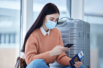 Image showing Passport, phone and covid woman travel at airport with mask, for holiday and trip. Female, check flight cancellation schedule online and with protection against coronavirus or traveling restriction