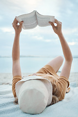 Image showing Book, beach and woman reading on holiday for calm, peace and travel by the ocean in Bali during summer. Free, relax and girl with novel on the tropical sand while on an island vacation in nature