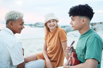 Image showing Guitar, relax and friends on holiday at the beach with music from a musician in Spain during summer. Happy, young and travel people playing ukulele instrument on vacation by sea for peace and calm