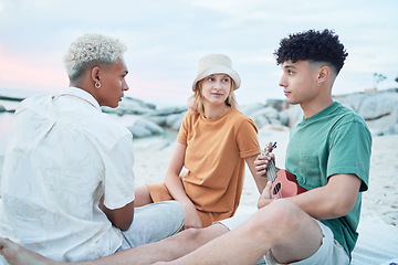 Image showing Guitar, beach and friends on holiday at the sea in Spain with music from a musician for peace and calm in nature. People listening to sound from playing ukulele during vacation for travel by ocean