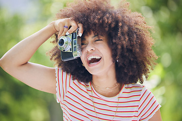Image showing Nature, afro and black woman with photography camera taking happy picture memory with retro style. African hipster girl with smile in park using vintage photographer equipment to capture moment.