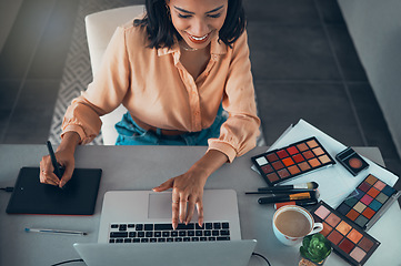 Image showing Graphic designer designing marketing advert for beauty products, makeup and cosmetics on laptop from above. Top view of smiling entrepreneur or freelance worker checking creative work