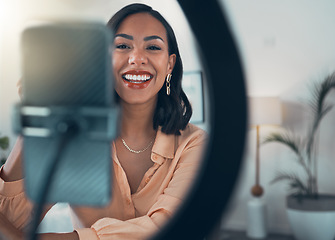 Image showing Influencer, lifestyle vlogger and content creator filming an online video at home. Stylish, smiling and creative female blogger live streaming, recording vlog and virtual broadcast for social media