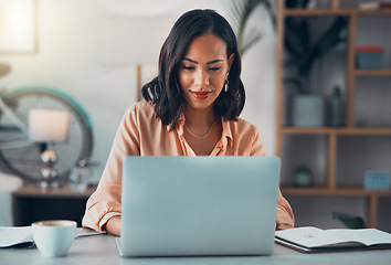 Image showing Woman working on laptop online, checking emails and planning on the internet while sitting in an office alone at work. Business woman, corporate professional or manager searching the internet