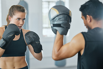 Image showing Boxing female boxer at gym with sports personal trainer practicing or training together for fight or match. Fitness and wellness coach teaching fit active athlete or client fighting exercise workout