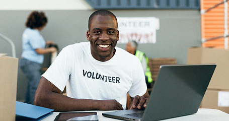 Image showing Volunteer man, laptop and portrait for donation, clothes drive and smile for community service, scroll and web. African person, pc and social responsibility with boxes, charity and ideas for helping