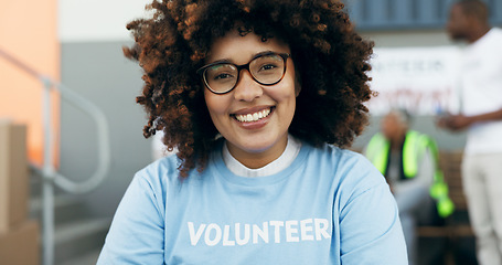 Image showing Volunteer woman, portrait and happy for charity, clothes drive and community service with kindness at desk. African girl, ngo and social responsibility with donation boxes, care or smile for helping