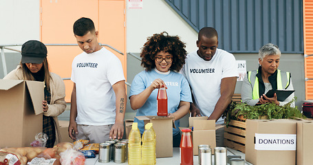 Image showing Group of people, volunteering and groceries on table for charity event with care, kindness and help. Community donation, men and women at ngo checking food package distribution at non profit project.