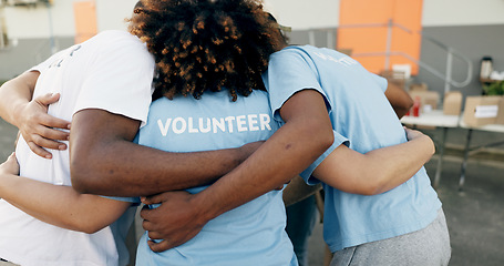 Image showing Community, charity and a volunteer group in a huddle together for teamwork, unity or solidarity. Recycle, team building and sustainability with ngo people hugging in support of an earth day project