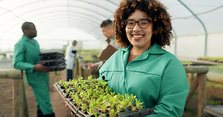 Image showing Woman, tray of plants and portrait in greenhouse for agriculture, eco friendly gardening and sustainable farming. Farmer or people with green sprout, vegetables growth and happy for agro development