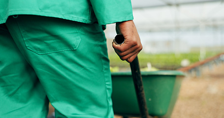 Image showing Hand, wheelbarrow and a farmer in a greenhouse for growth, agriculture or sustainability in season. Back, closeup and a equipment on a farm with a person in the countryside for environmental ecology