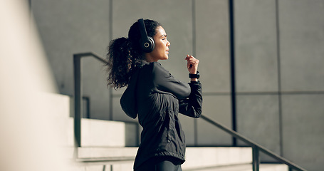 Image showing Runner woman, headphones and stretching on stairs for music, vision and idea in city, workout or training. Girl, thinking and listen on steps with audio streaming subscription, wellness and exercise