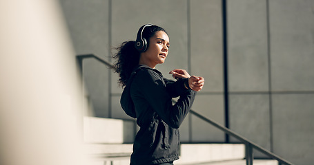 Image showing Runner girl, headphones and stretching arms on stairs for music, vision and ideas in city, workout and training. Woman, thinking and listen on steps with streaming subscription, wellness and warm up