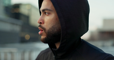 Image showing Fitness, face and thinking, man in city on rest from morning workout challenge in hoodie. Relax, breathing and tired athlete on calm urban exercise with fatigue, reflection and outdoor fresh air.