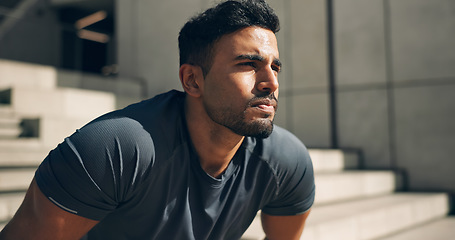 Image showing Face, exercise and a tired sports man outdoor in the city for commitment to health or wellness. Fatigue, breathing and sweating with an exhausted young athlete in an urban town for fitness training