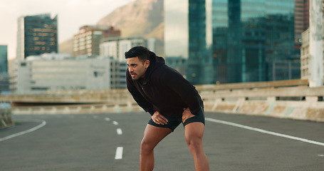 Image showing Man, athlete and breathe in road for fitness, exercise or wellness with city background or nature. Runner, person and break or tired for workout, training and healthy body with sportswear in street